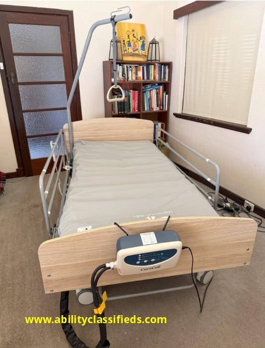 Unicare Adjustable single nursing bed, monitored air inflation mattress & over bed table